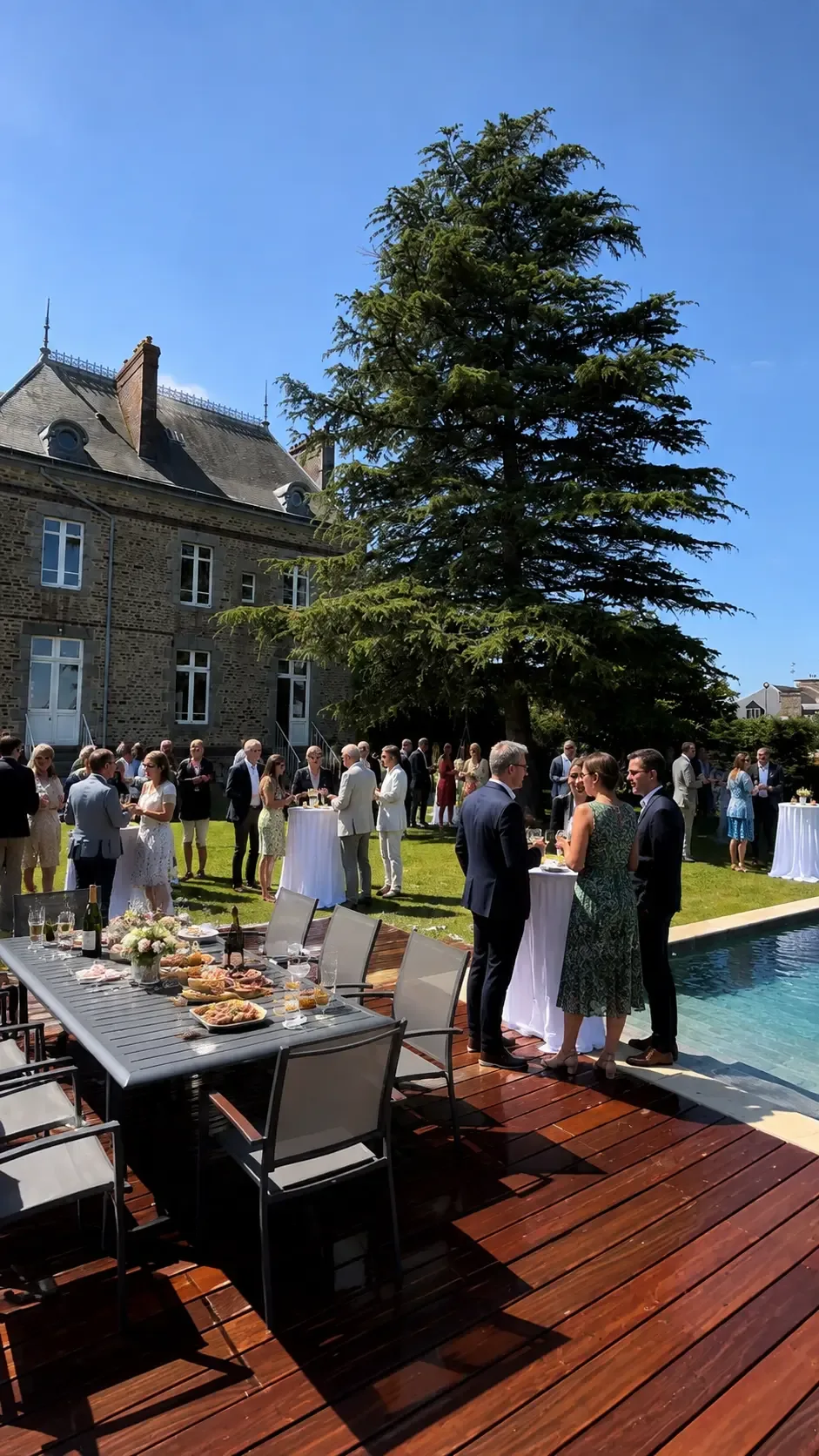 A company gathering beside the pool at the manor