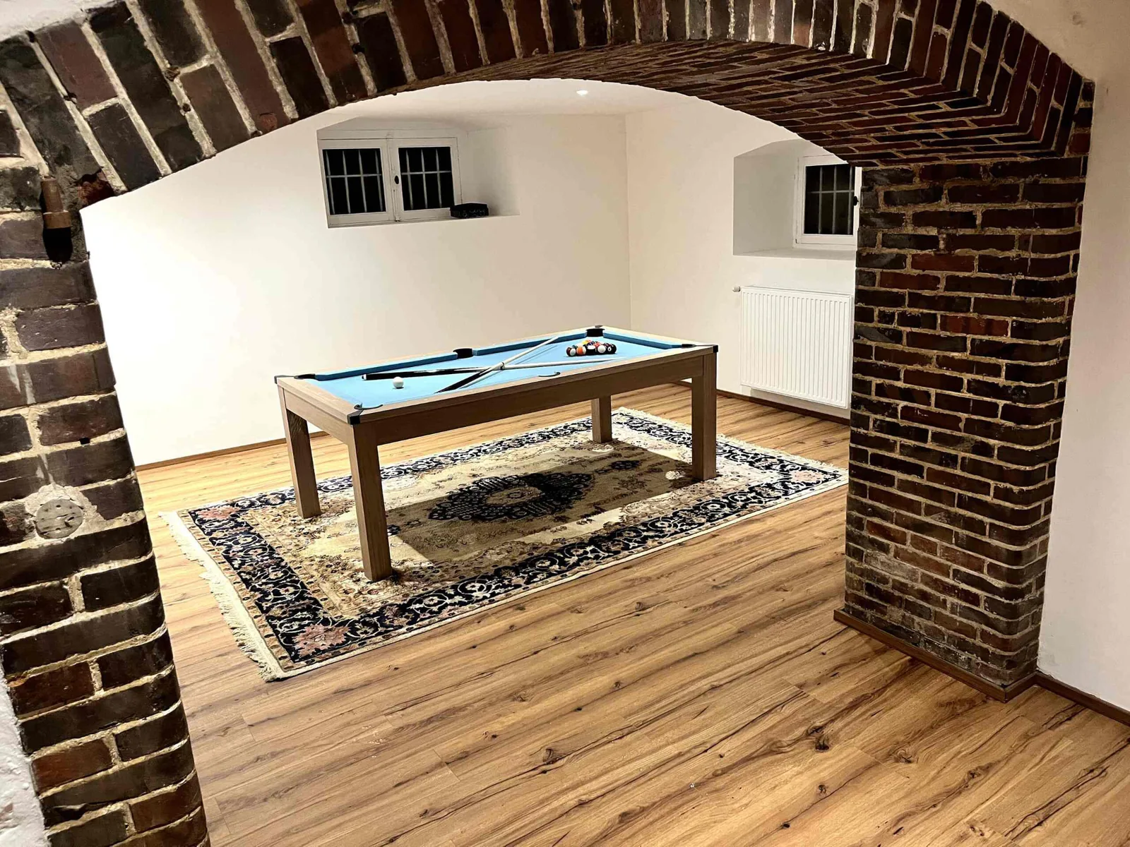 Billiards table under the brick vault in the games room at Le Manoir Ducey