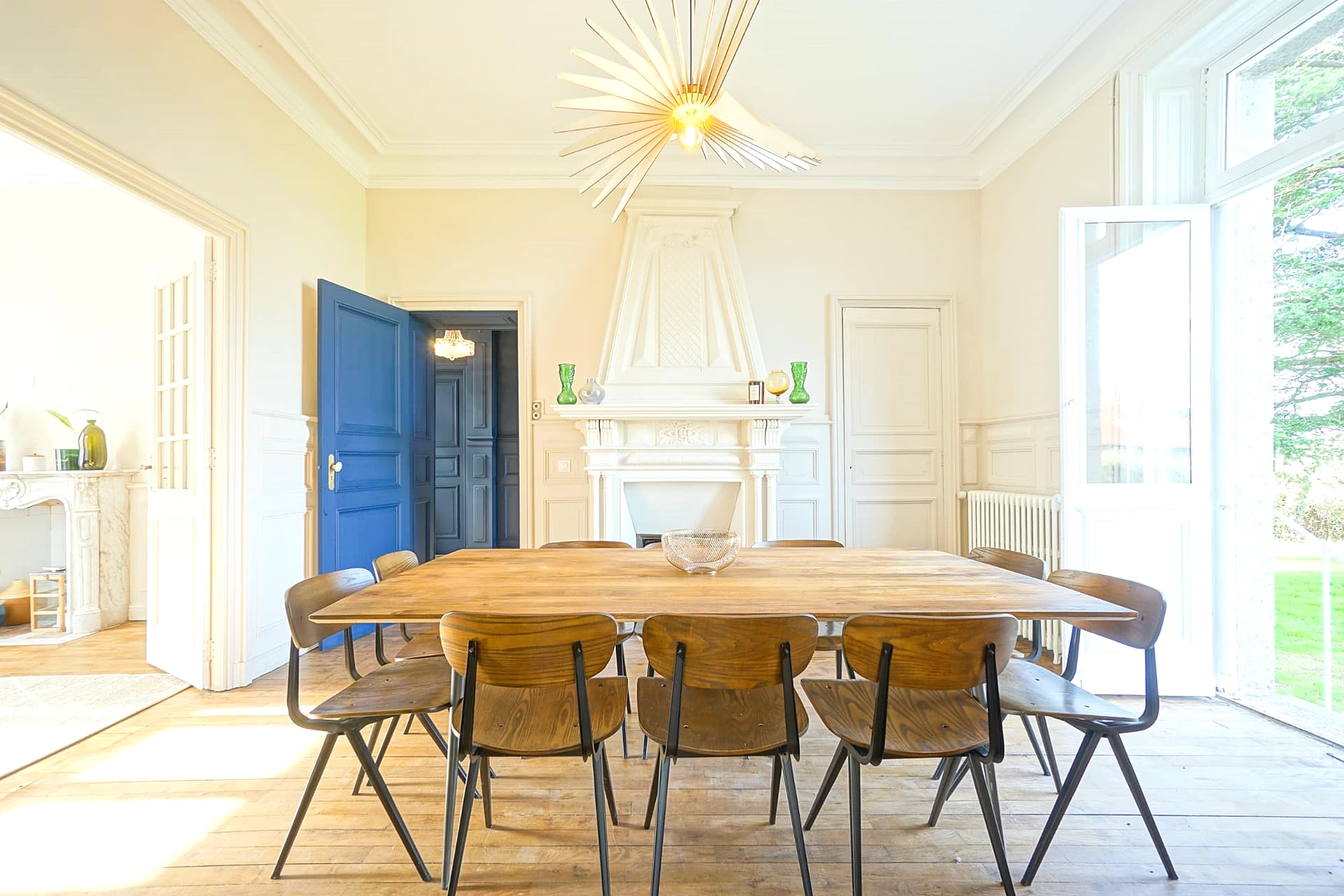 Dining room at Le Manoir Ducey with a long table and original fireplace