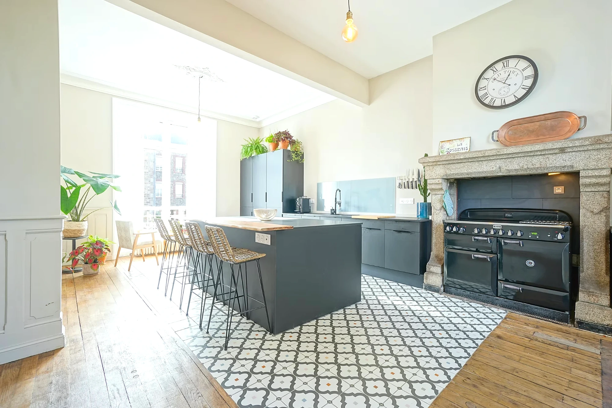 Family kitchen at Le Manoir Ducey with range cooker and granite fireplace