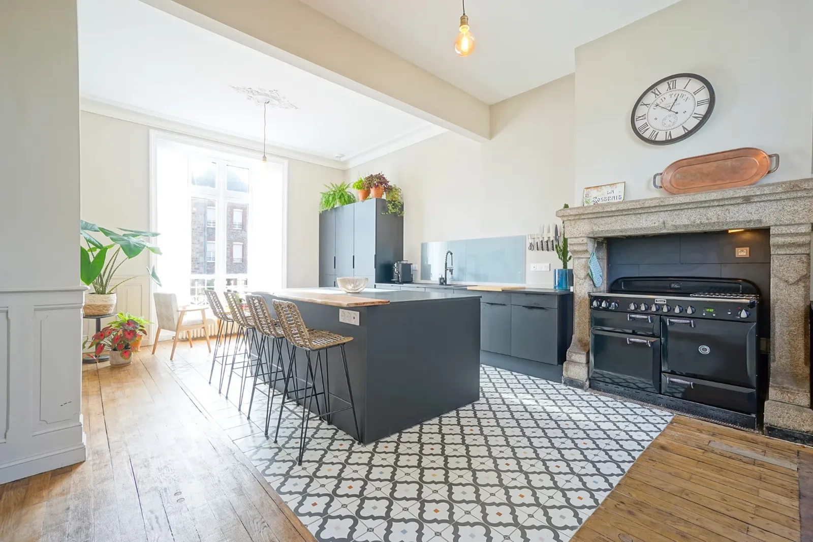 Kitchen at Le Manoir Ducey with range cooker, granite fireplace and central island